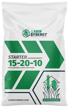 A white bag of Lawn Synergy Starter 15-20-10 professional lawn fertilizer with green geometric accents and branding.